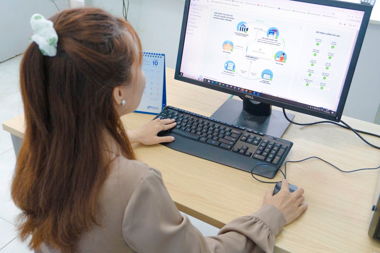 Woman Working on a Desktop in a Bright Office